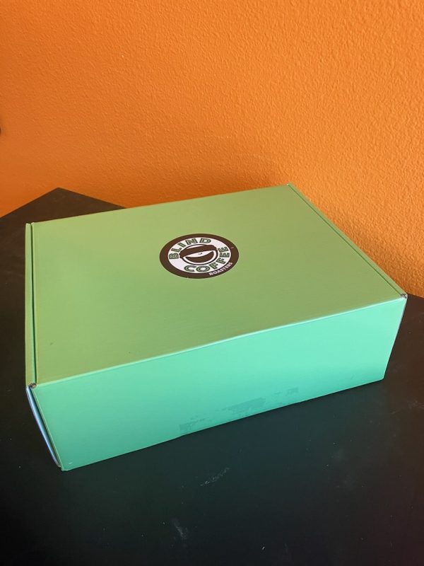 A green box with the BCR logo containing our Sample Pack of coffees